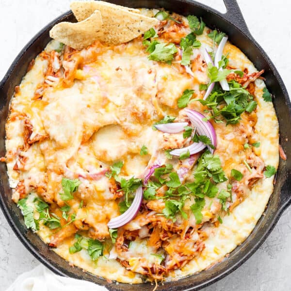 Cast iron skillet filled with bbq chicken dip.
