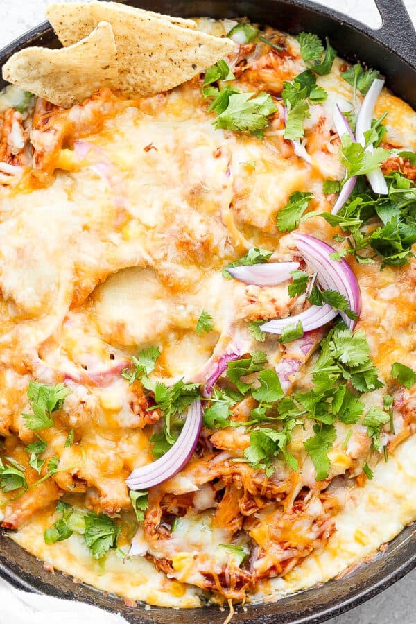 Cast iron skillet filled with bbq chicken dip.