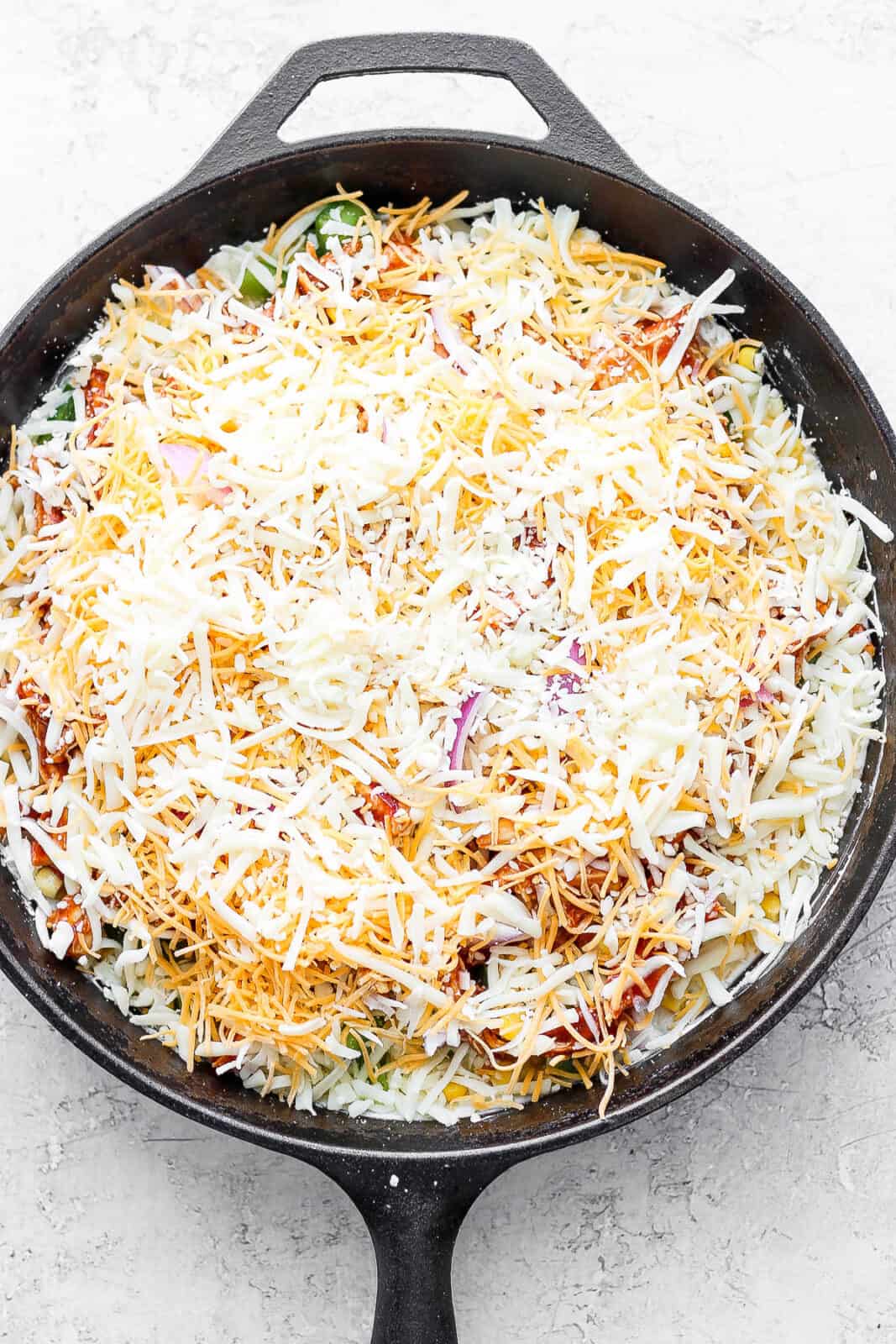 Shredded cheese added on top of everything.