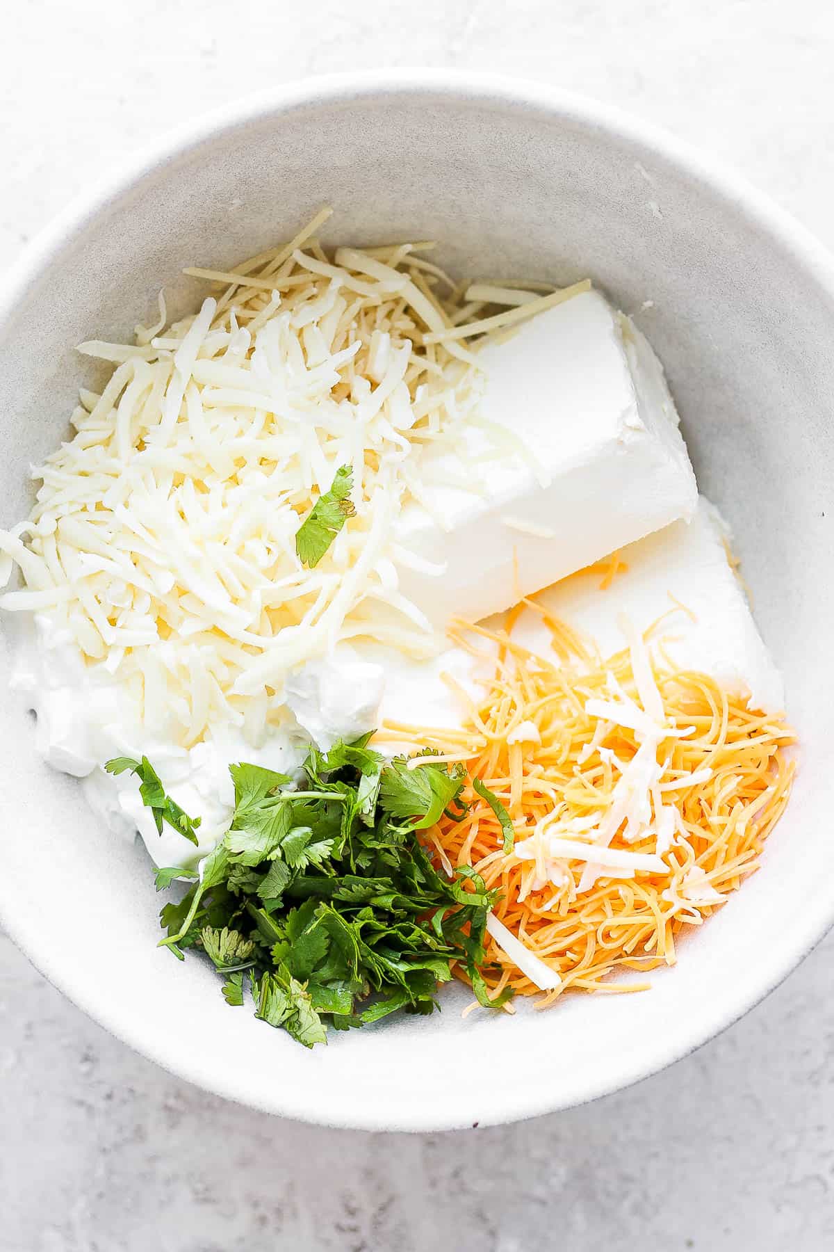 Cream cheese base ingredients in a bowl, uncombined.