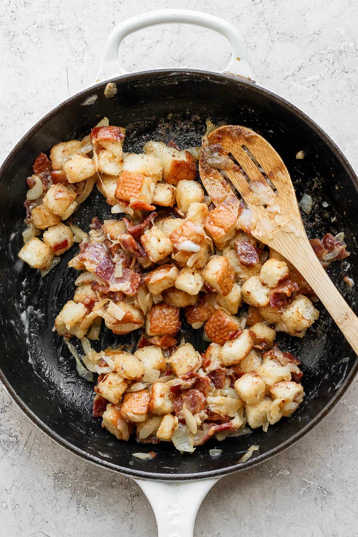 A cast iron skillet filled with stuffing.