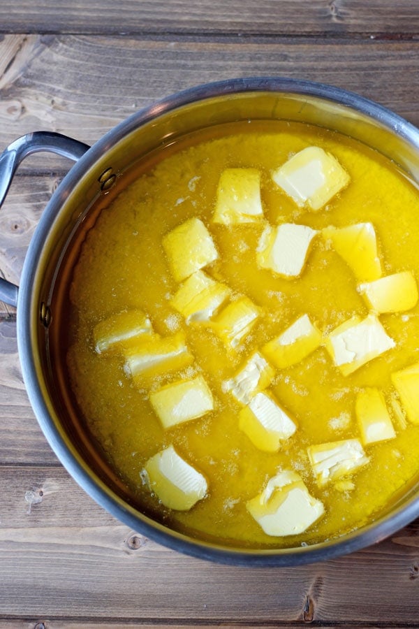 Chunks of butter half-melted in a deep skillet. 