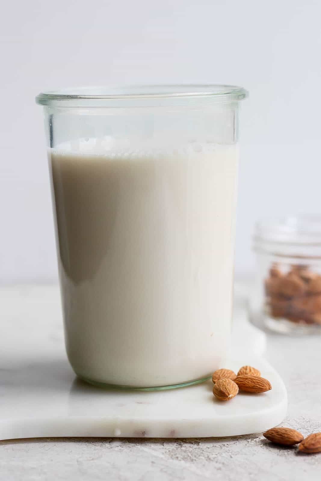 A glass jar of homemade almond milk. 