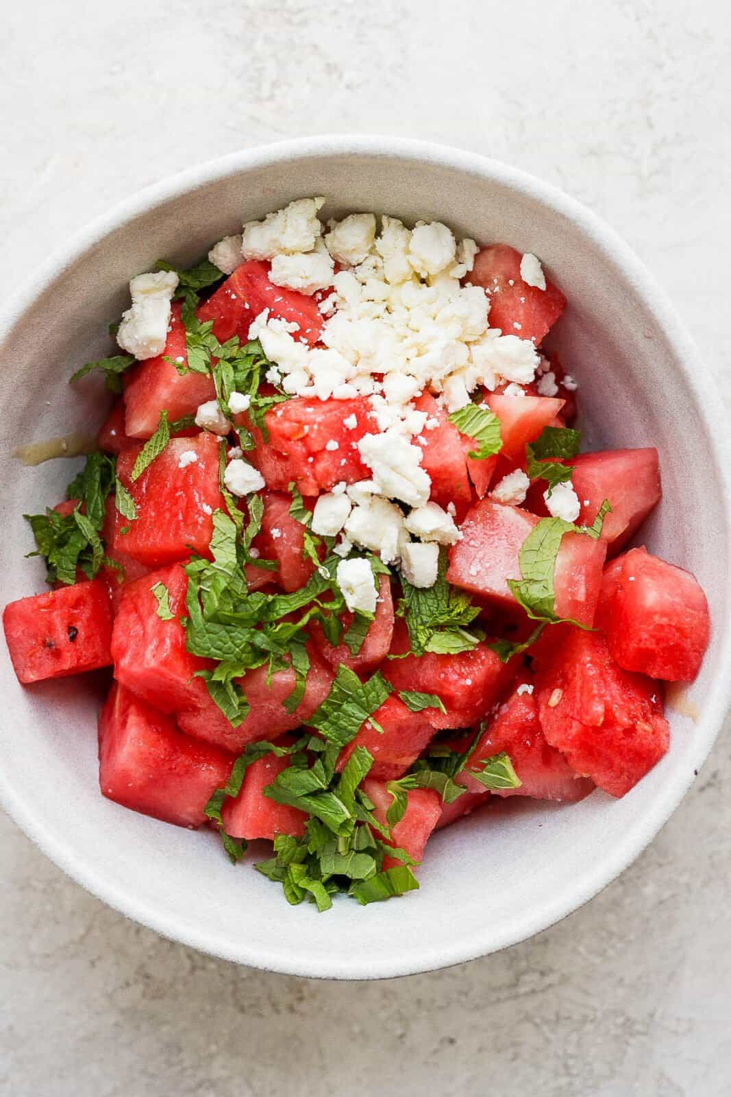 A bowl of watermelon, mint and feta.