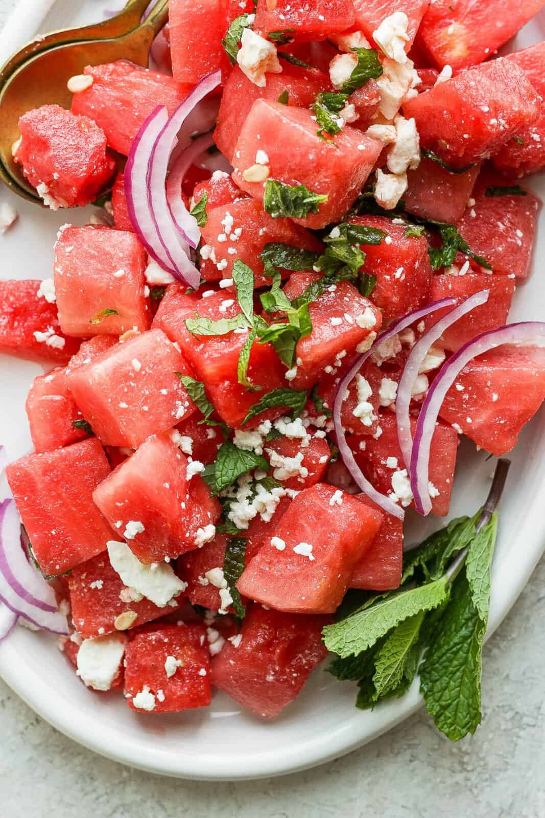Top shot of a watermelon feta salad with red onion and mint. 