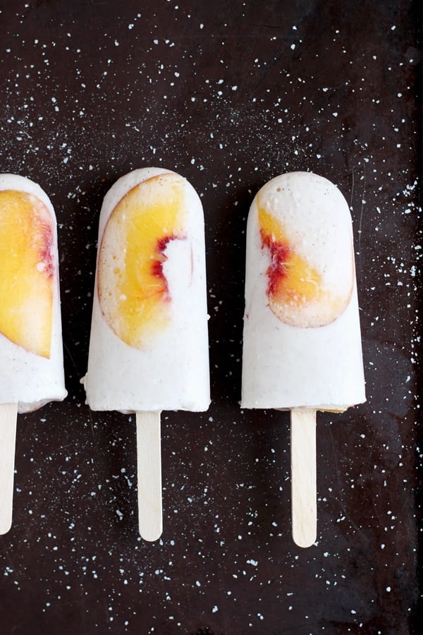 Vegan peaches and cream popsicles on the counter.