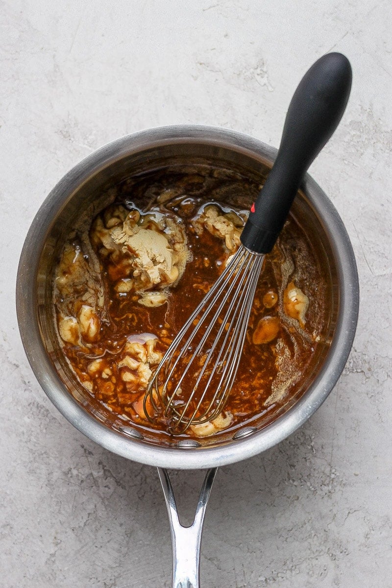 Small saucepan with maple syrup, coconut sugar and vegan butter inside.