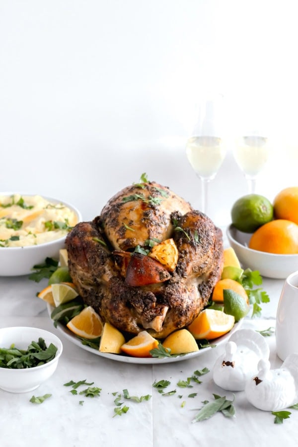 A fully cooked roasted turkey on the table with side dishes.