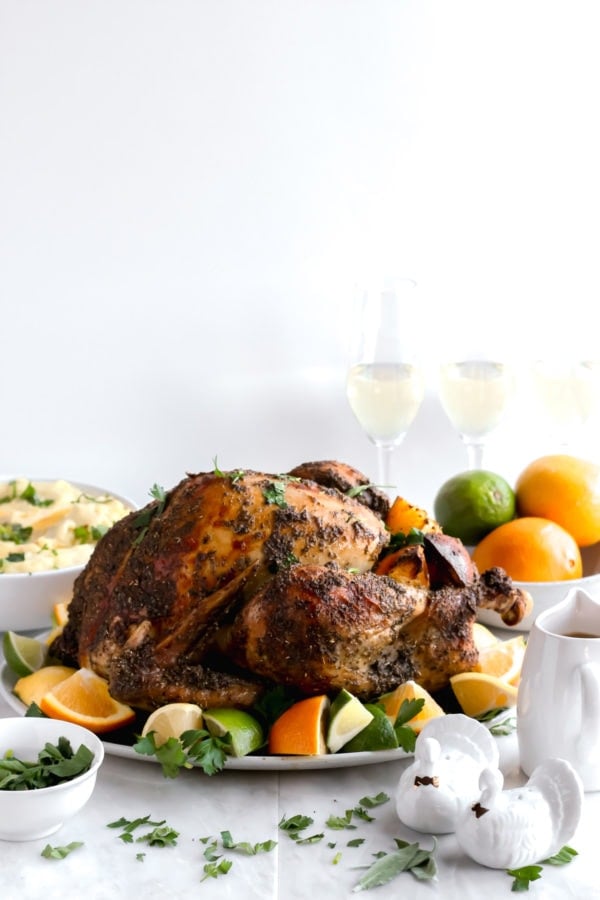 An herb citrus roasted thanksgiving turkey on a Thanksgiving table.