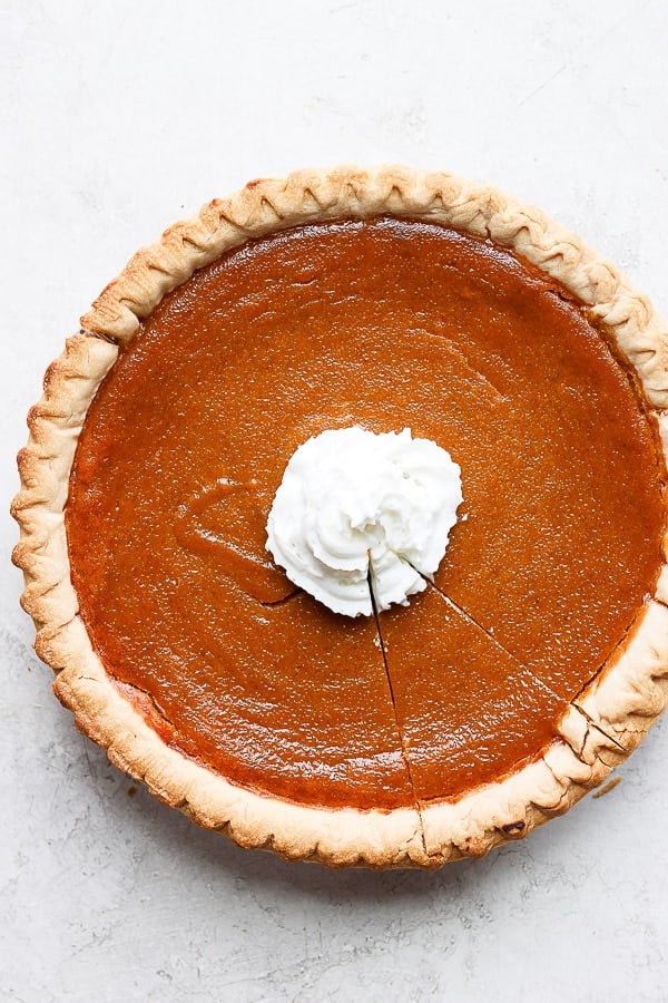 Dairy free pumpkin pie with whipped coconut cream in the center. 