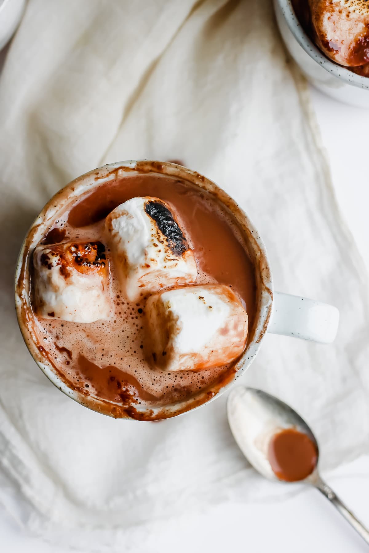 Top shot of hot chocolate in mug with marshmallows on top.