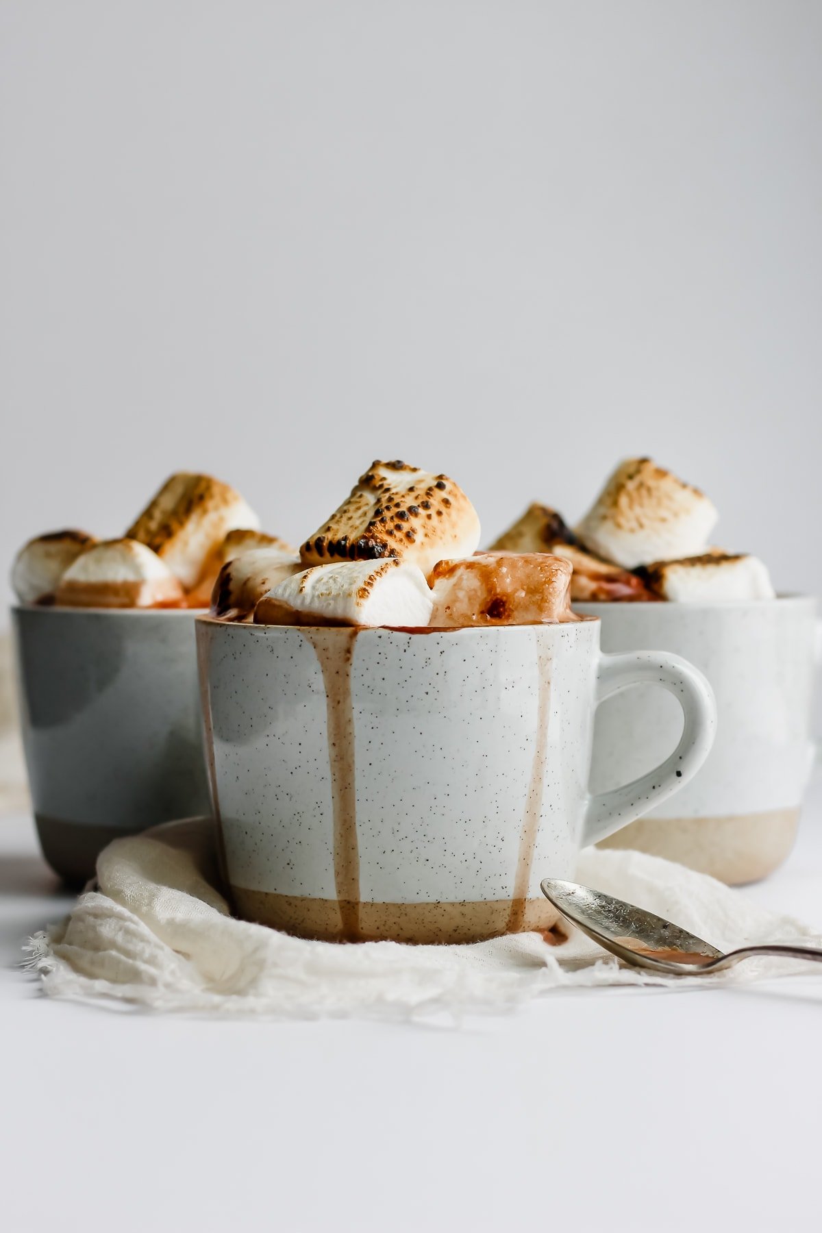 Three mugs of hot chocolate.