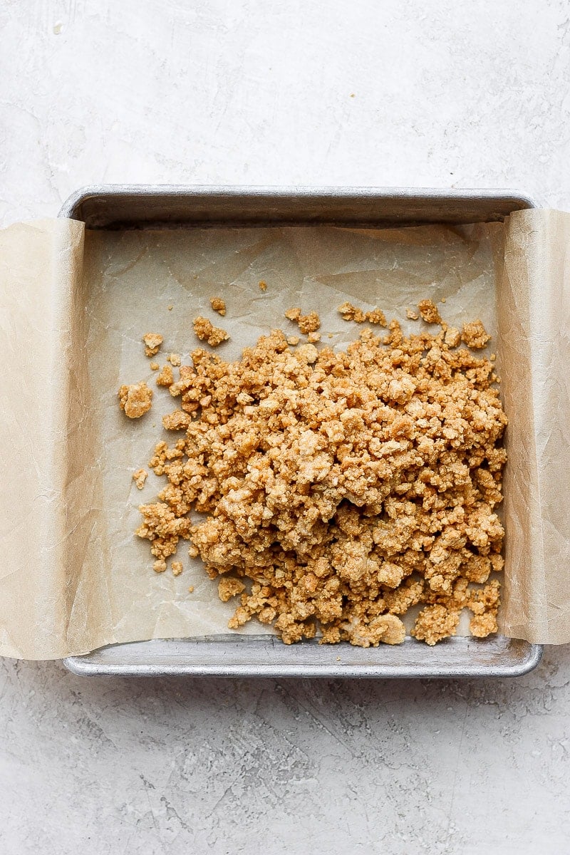 9x9 pan with parchment lining it and graham cracker crumble poured inside. 