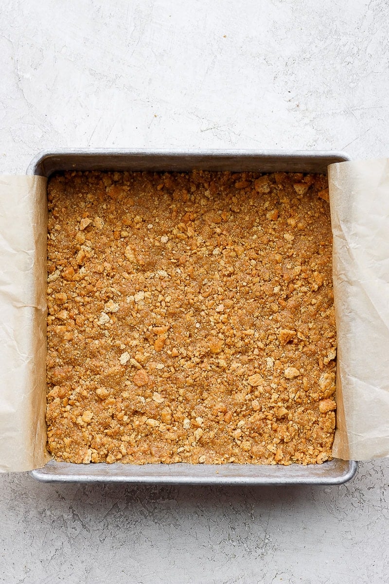 9x9 pan lined with parchment and a graham cracker crust pressed down on the bottom. 