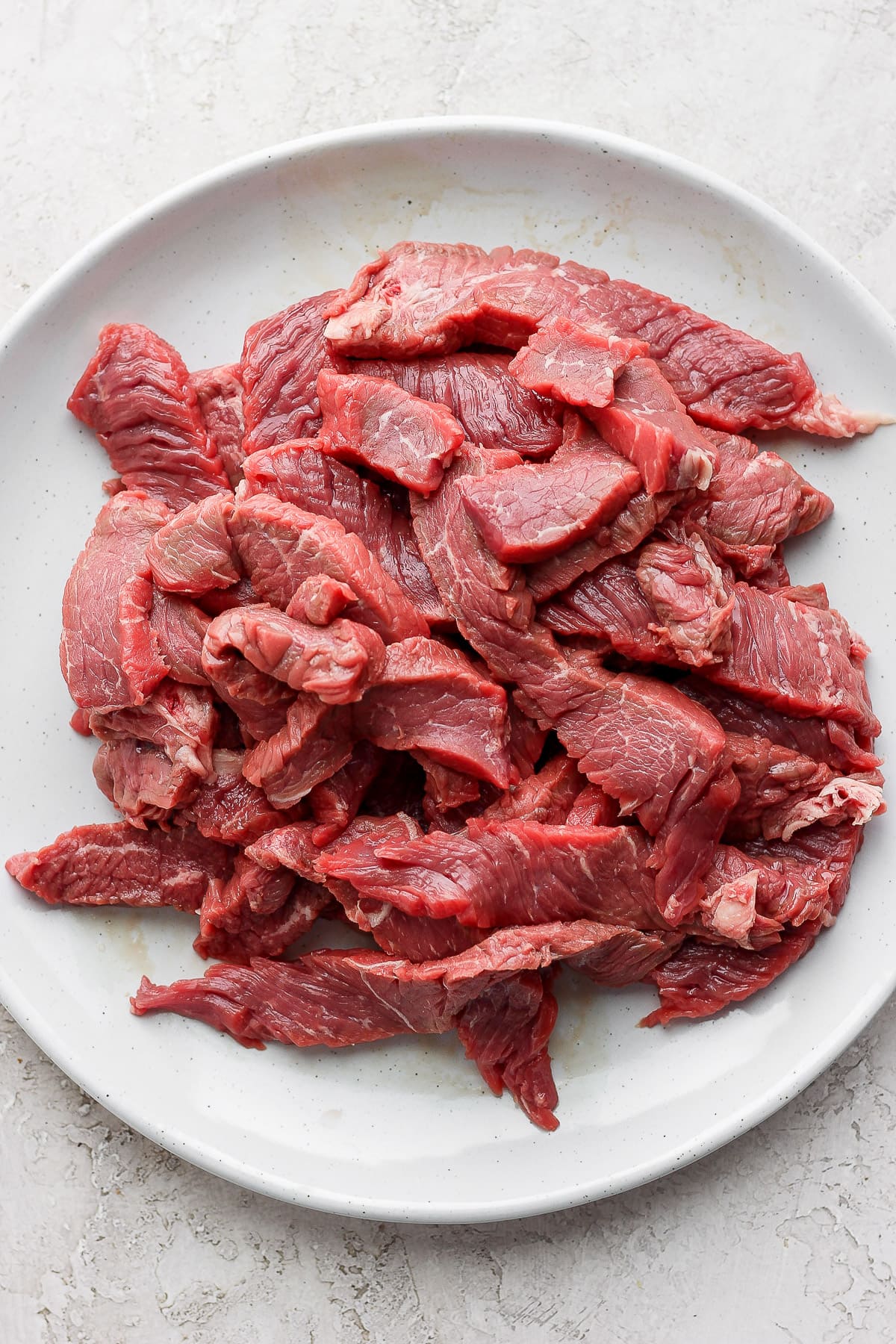 Steak strips on a white plate.