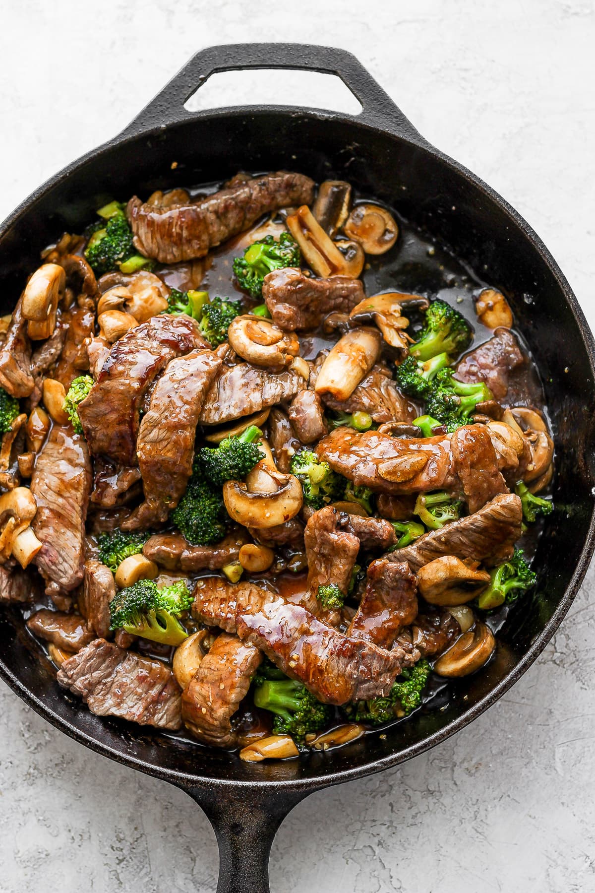 Cast iron skillet of healthy beef and broccoli. 