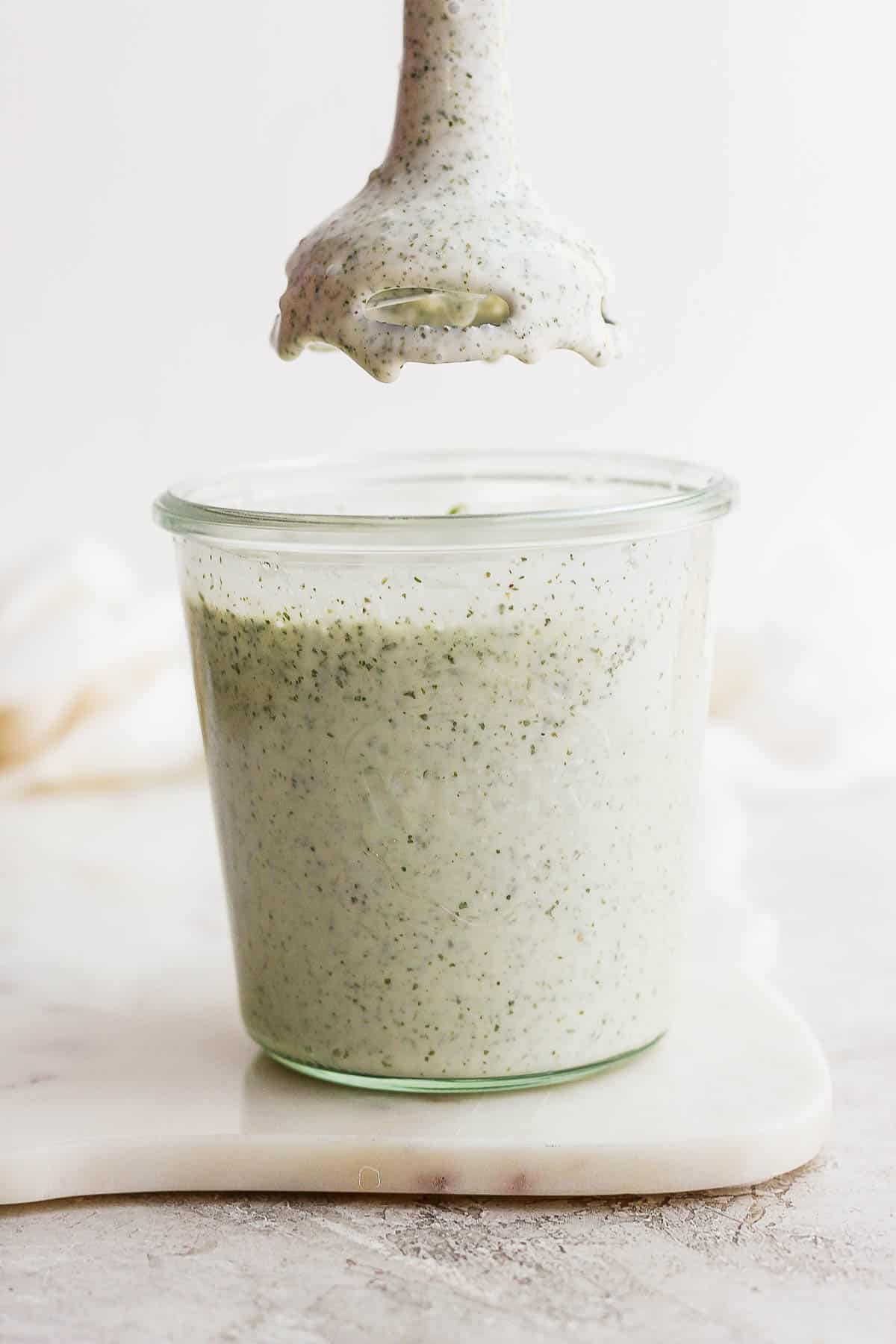 Ranch dressing in a glass jar.