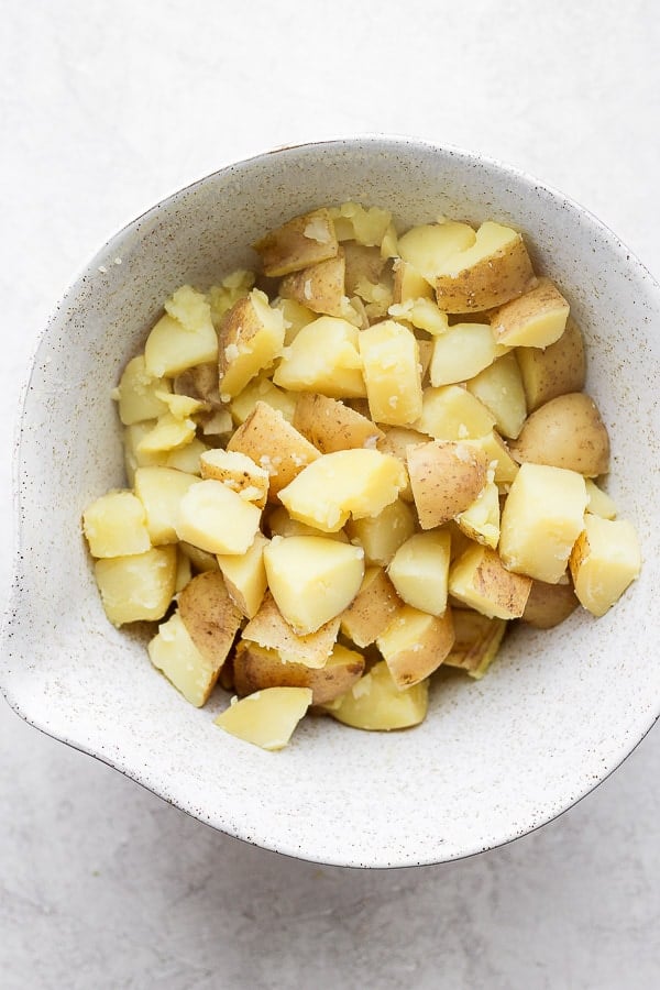 Chunks of potatoes in a bowl after being boiled.