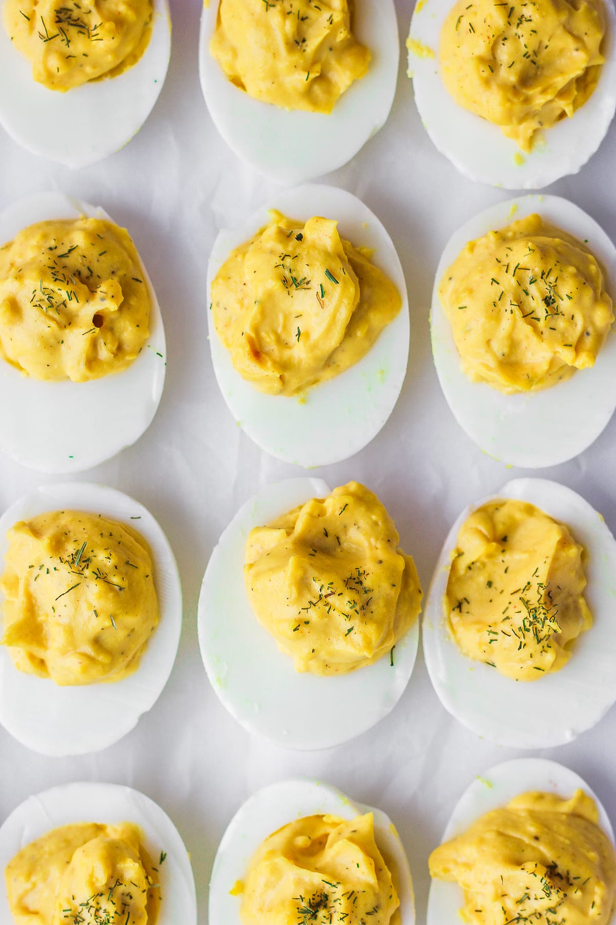 9 deviled eggs on a white counter.