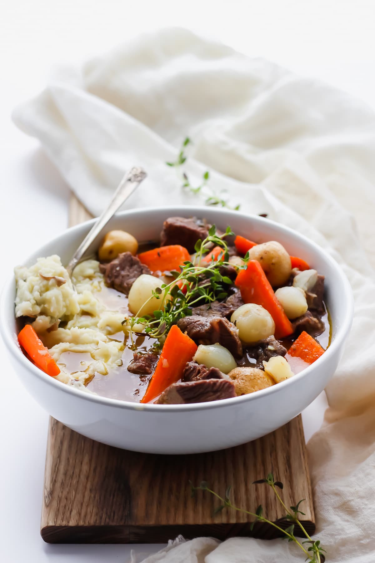 Irish beef stew over mashed potatoes in a bowl.