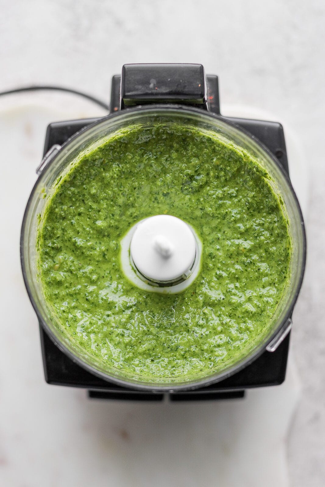 Homemade dairy-free pesto in a food processor.