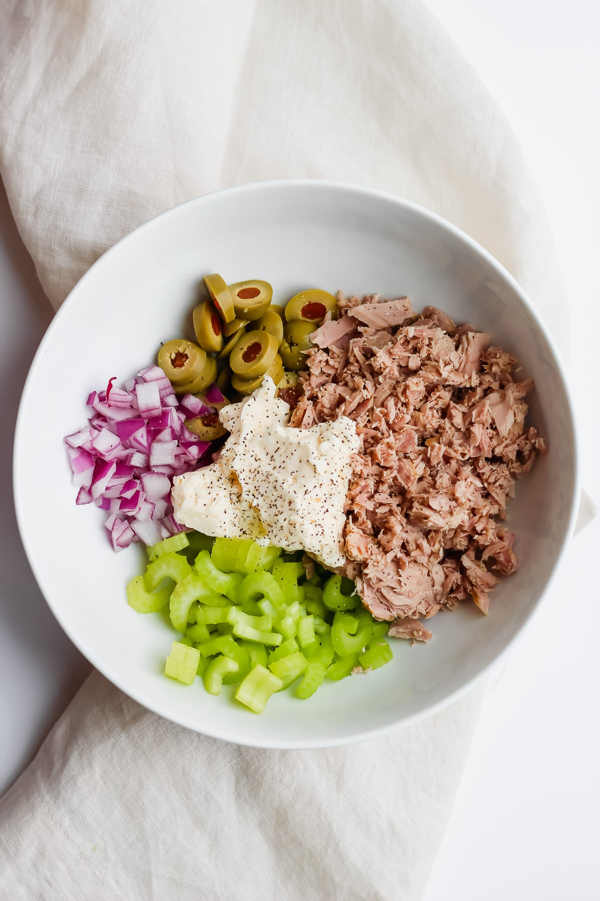 Bowl of healthy tuna salad ingredients that aren't mixed up yet.