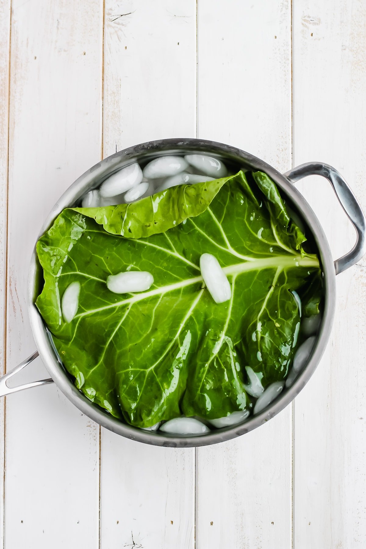 Collard leaf in an ice bath.