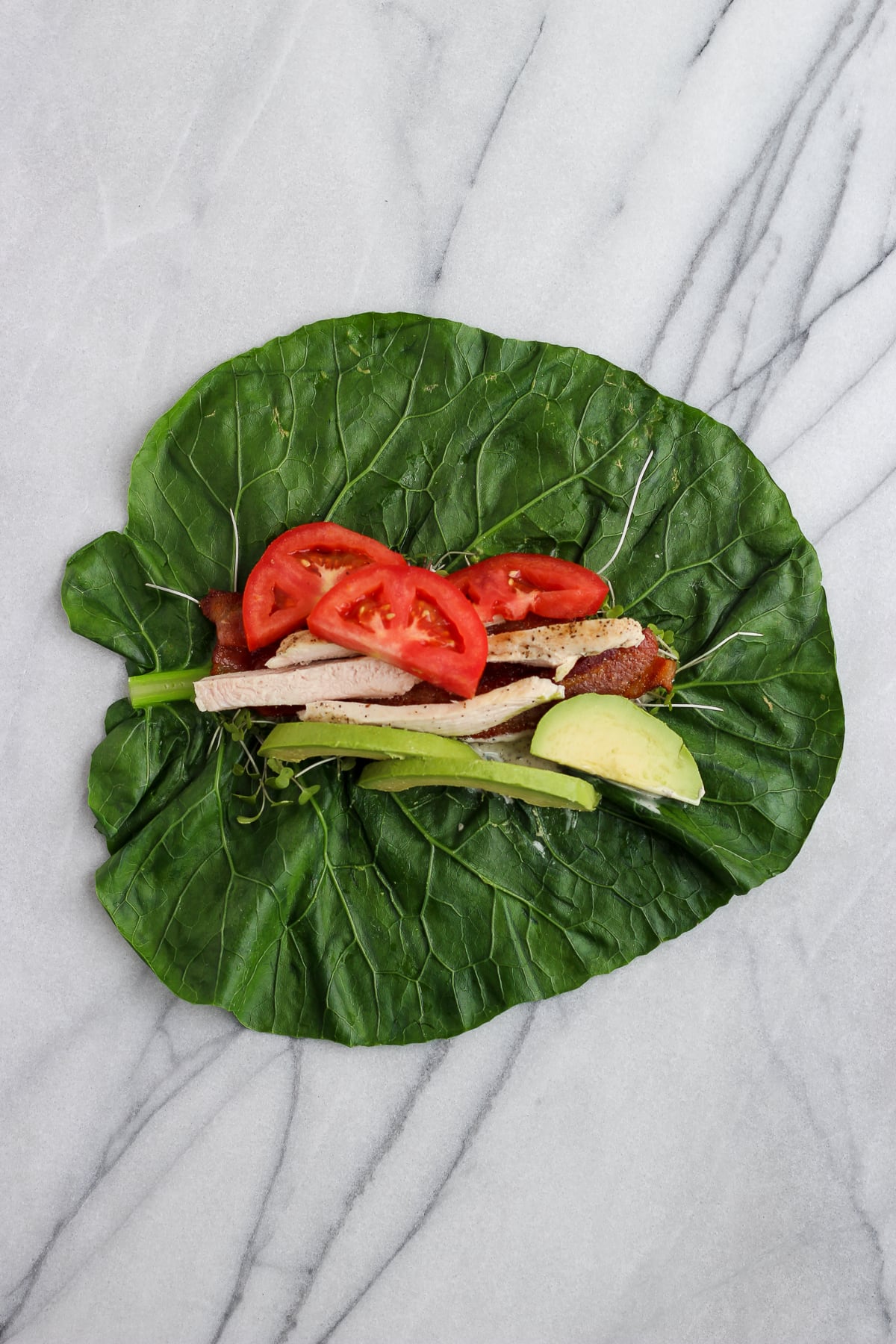 A collard green leaf with filling ingredients added to the middle.