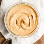 A top shot of a container of cashew butter.