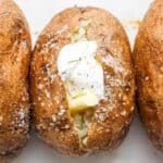 A baked potato with ghee and dairy free sour cream.