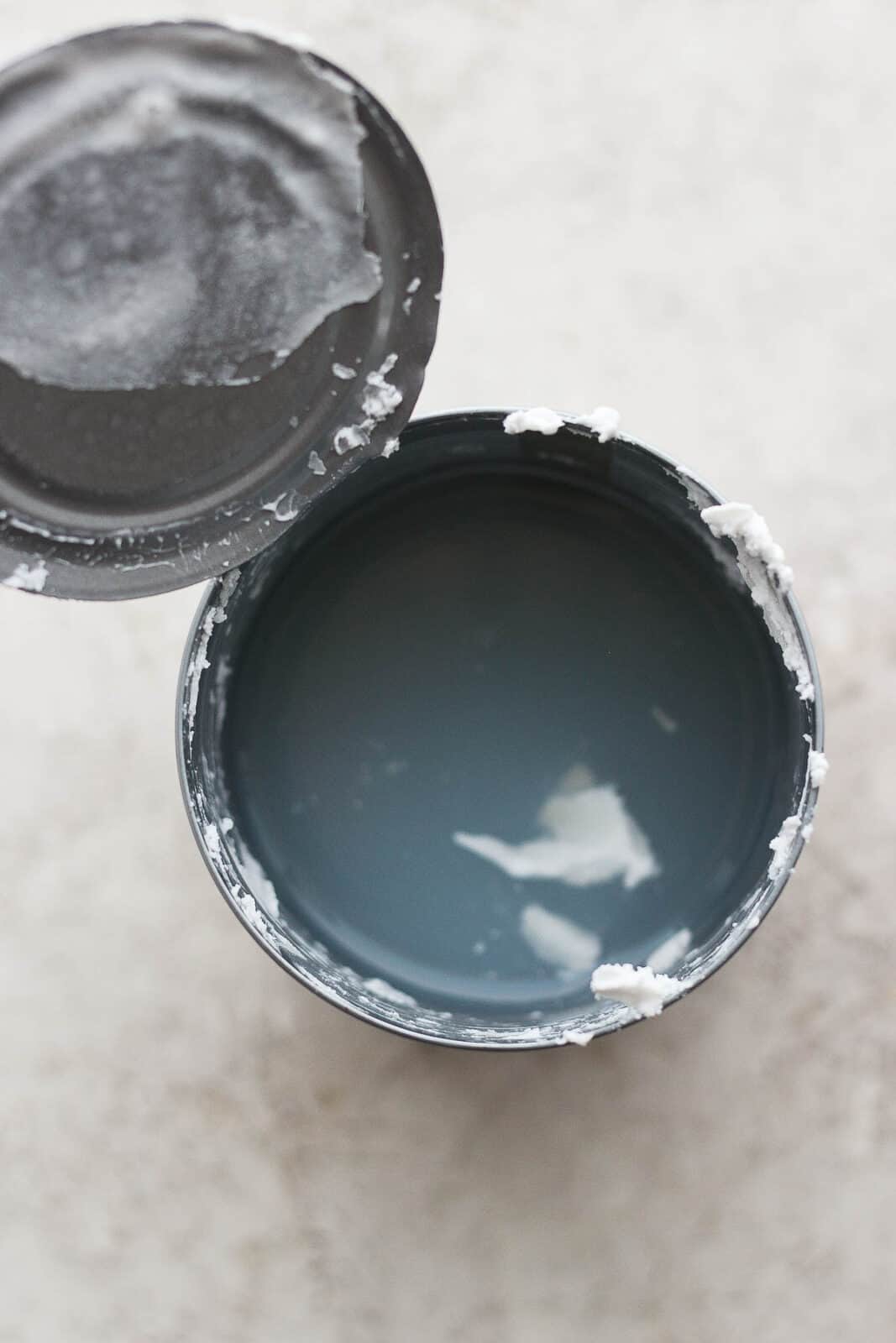 An open can of coconut milk showing the coconut cream removed and the coconut milk at the bottom.