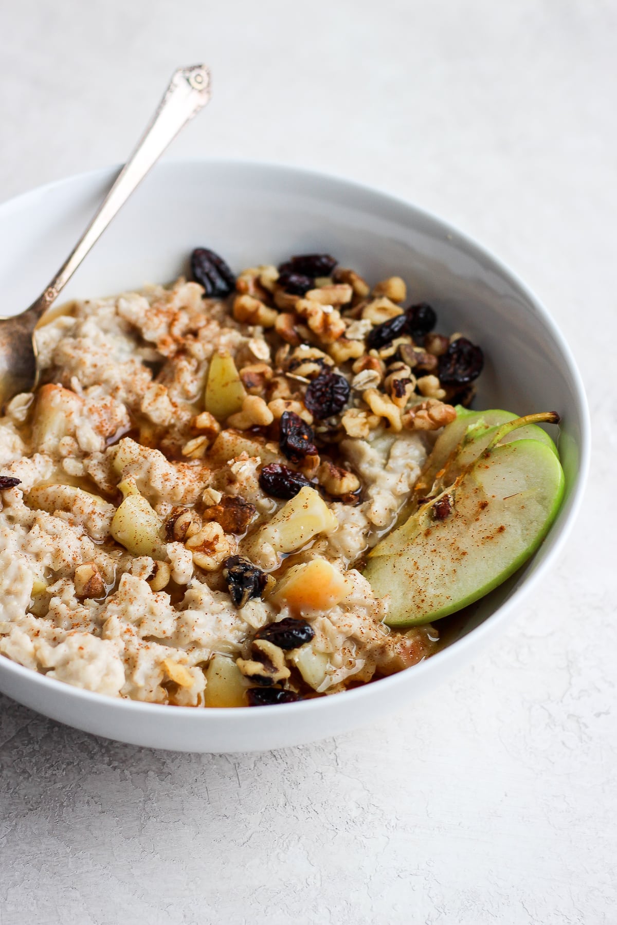 Apple pie oatmeal in a white bowl.