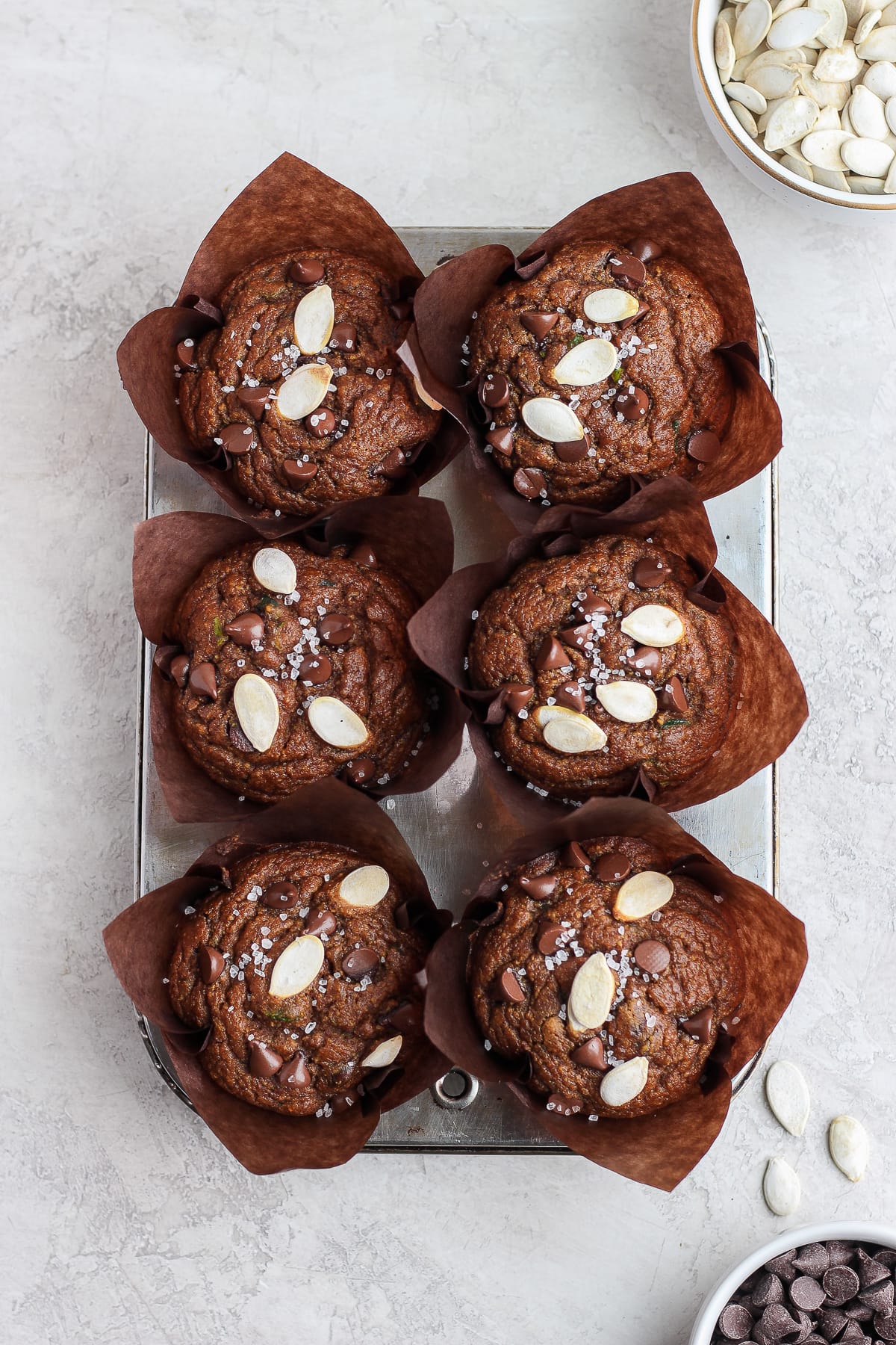 Six pumpkin zucchini muffins after baking.