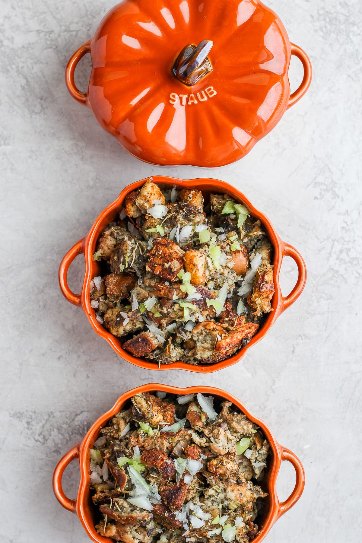 Three orange dishes of giblet stuffing.