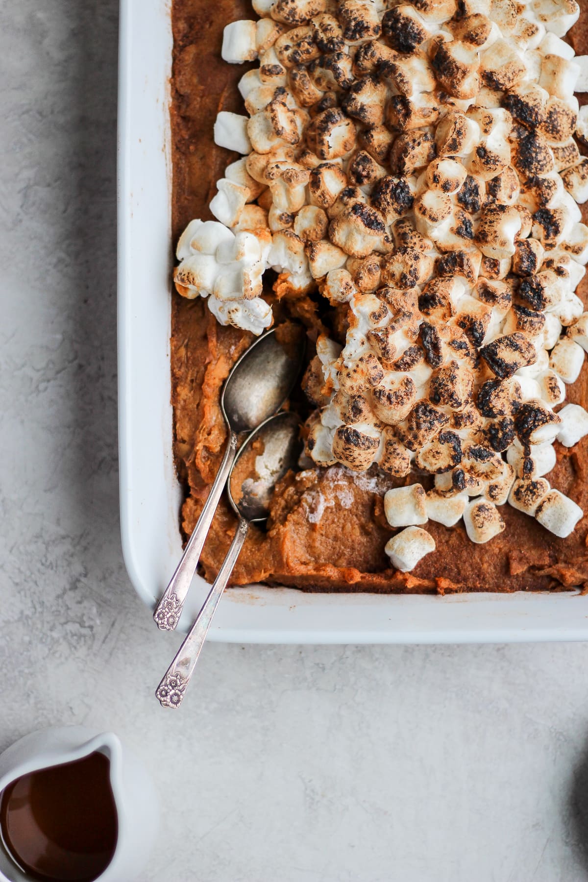Two spoons in the sweet potato casserole after baking.