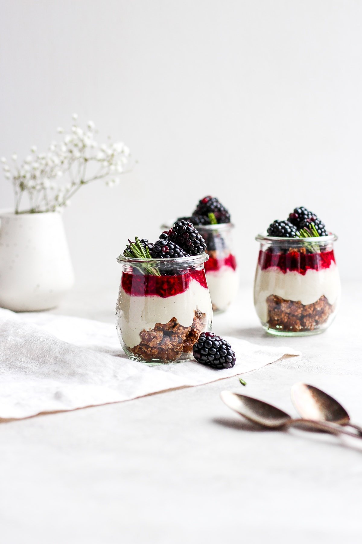 Three jars of vegan blackberry cheesecake.
