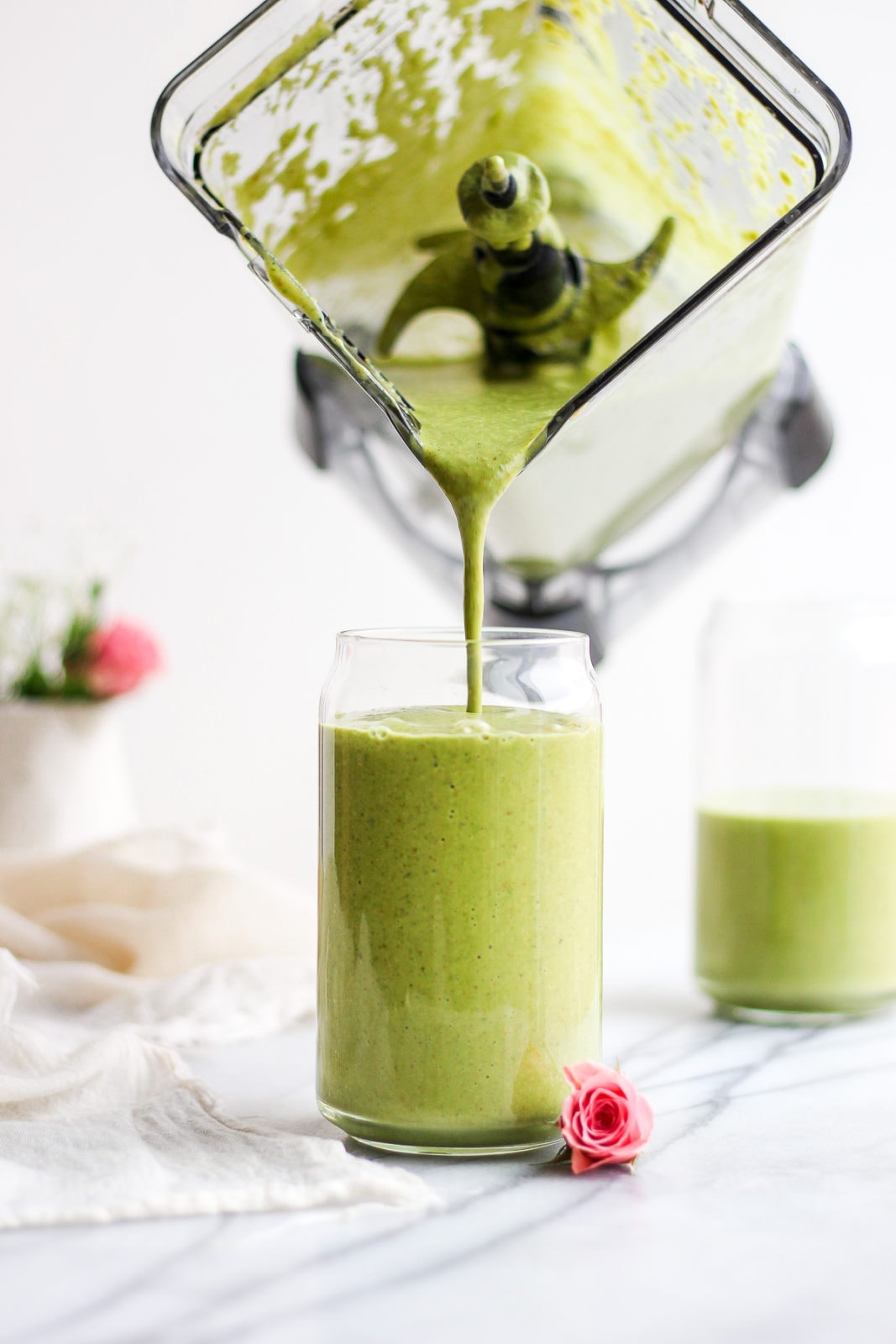 Creamy Avocado Collagen Smoothie being poured into a glass. 