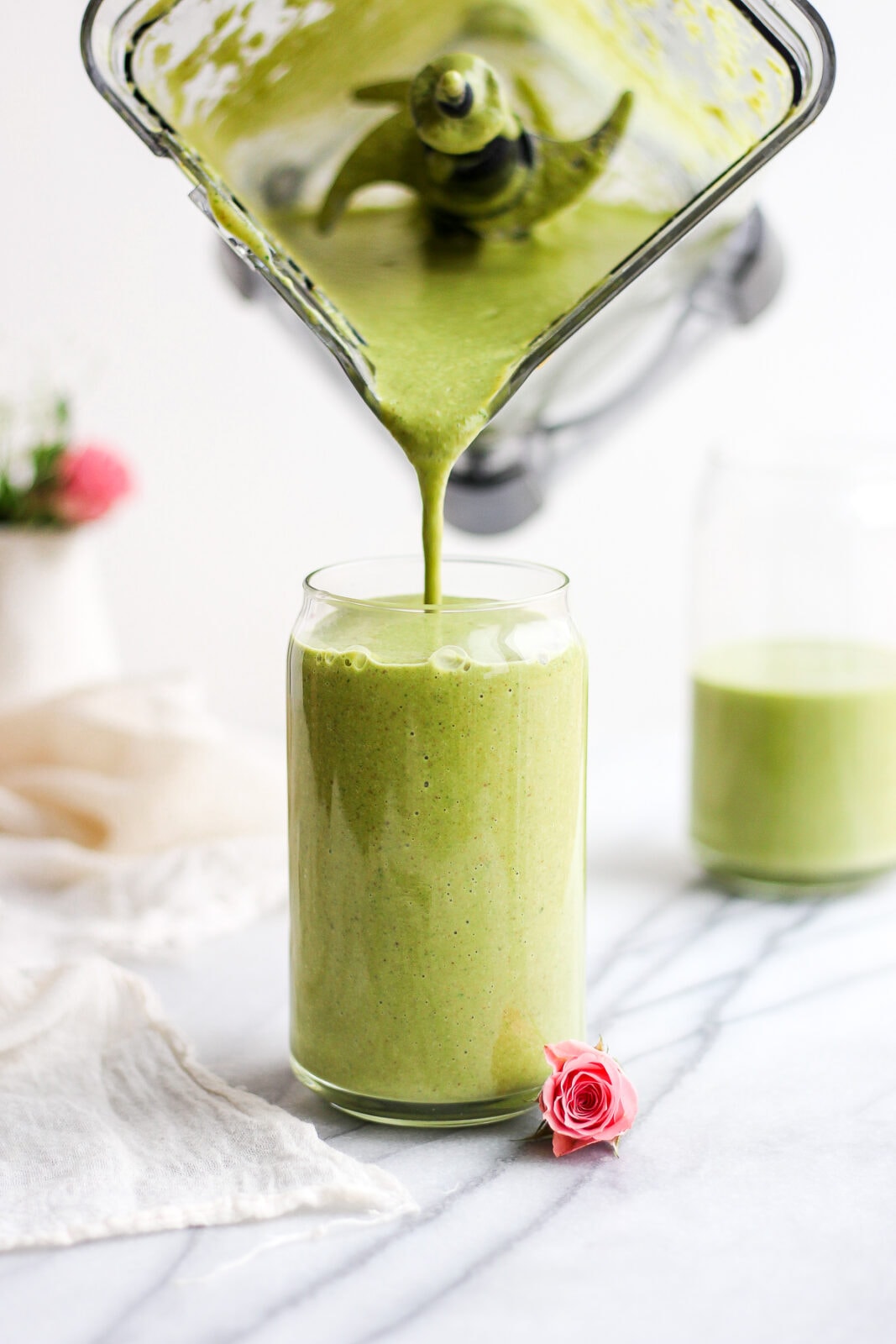 Creamy Avocado Collagen Smoothie being poured into a glass. 