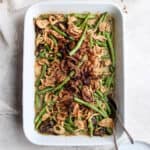 A 9x13 casserole pan filled with dairy free green bean casserole with fried onions on top.