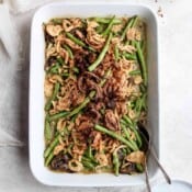 A 9x13 casserole pan filled with dairy free green bean casserole with fried onions on top.