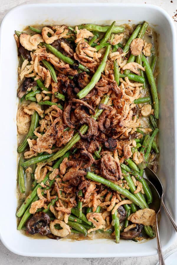 A 9x13 casserole pan filled with dairy free green bean casserole with fried onions on top.