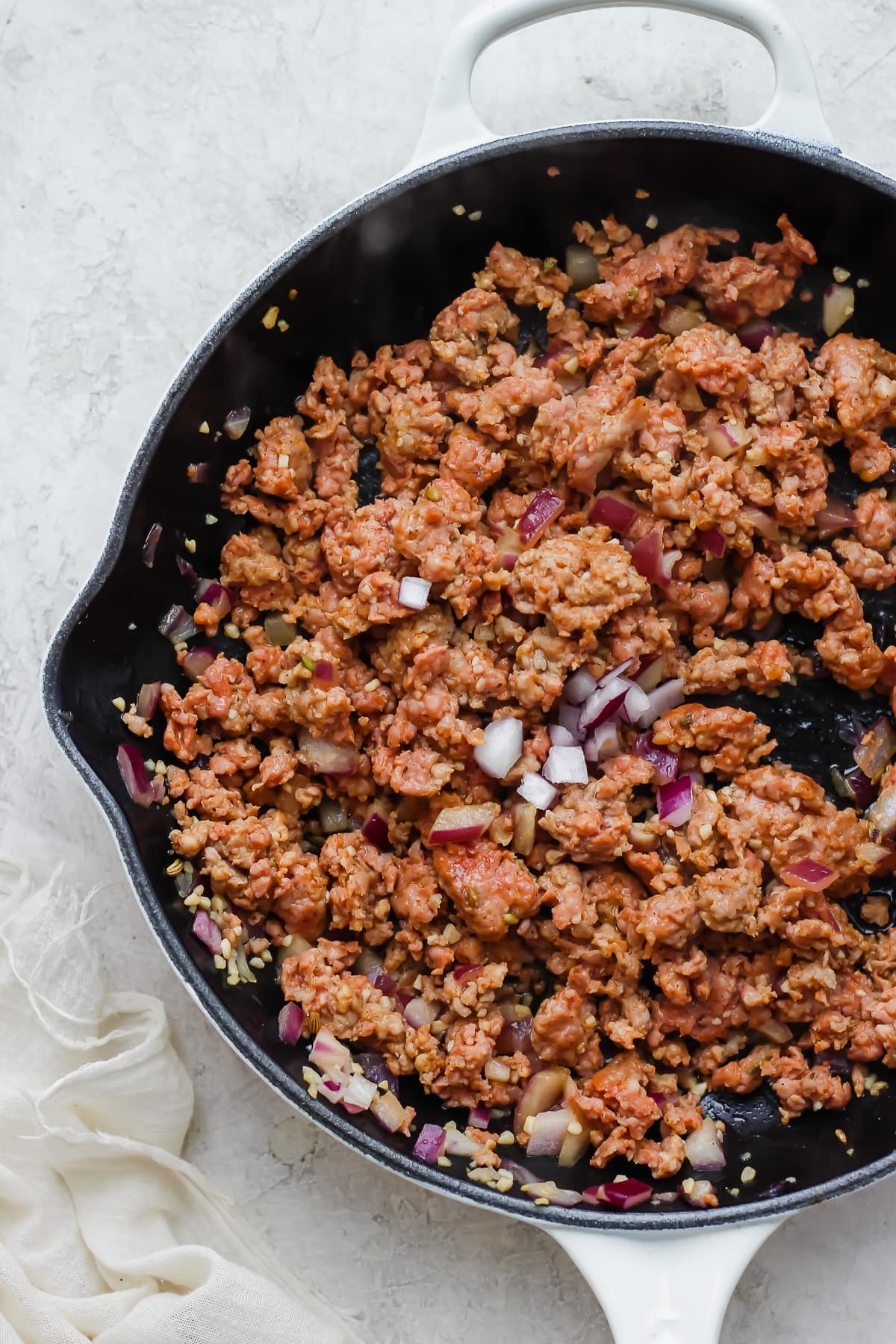 The fully cooked meat mixture in a cast iron skillet.