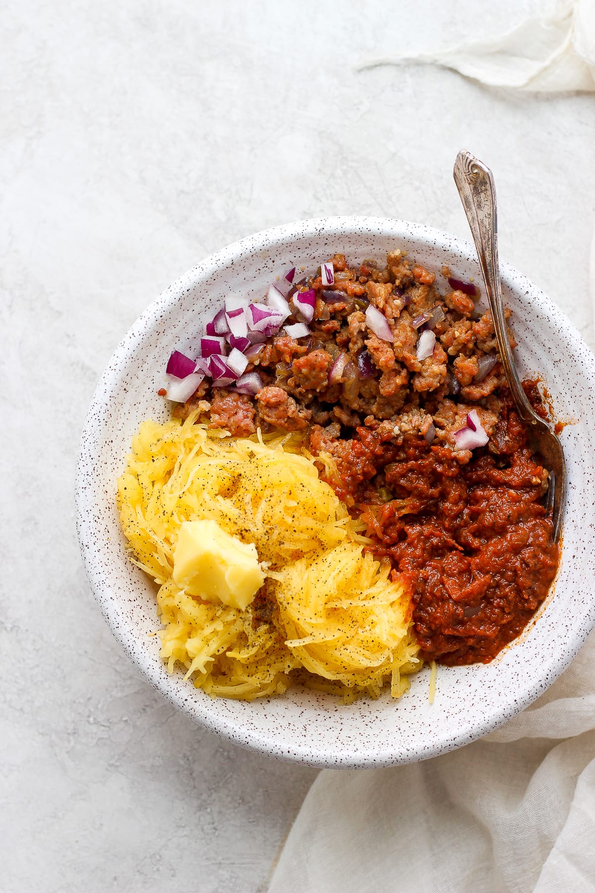An easy spaghetti squash bowl in a white bowl with a fork.