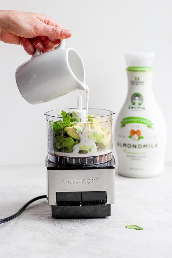 All of the sauce ingredients being added to a food processor.