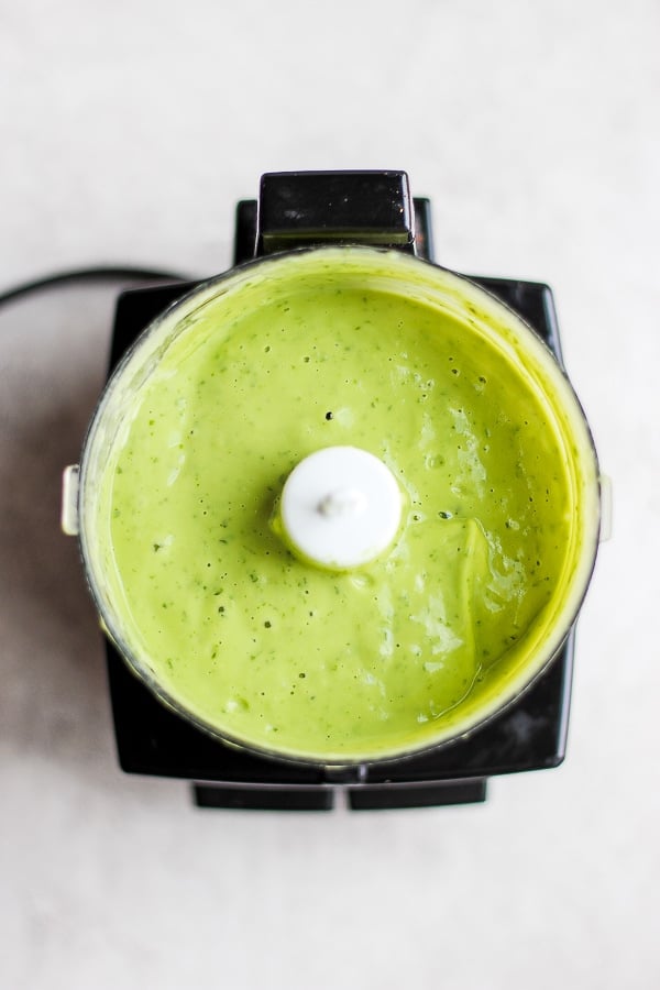 The creamy avocado sauce in a small food processor.