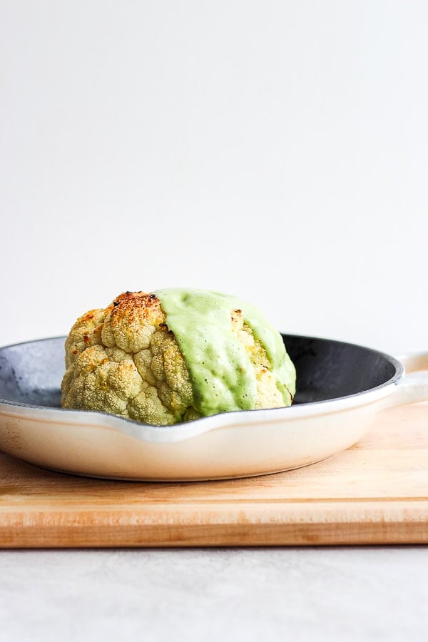 Avocado sauce on a head of cauliflower.