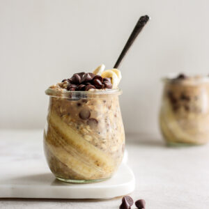 A jar of chocolate chip overnight oats with another jar in the background.