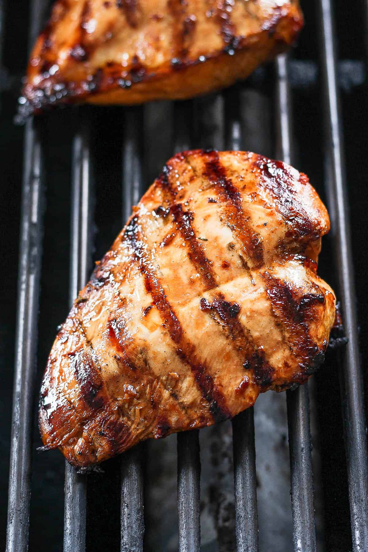 Grilled chicken breasts on the grill.