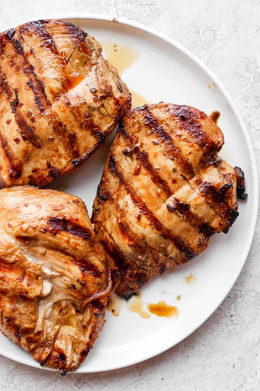 A plate of grilled chicken breast. 