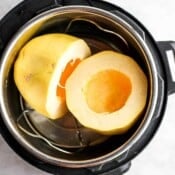 A spaghetti squash cut in half and placed in an Instant Pot on a trivet.